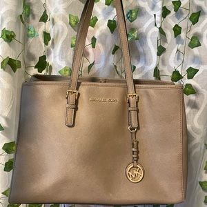 Beige Michael Kors purse.